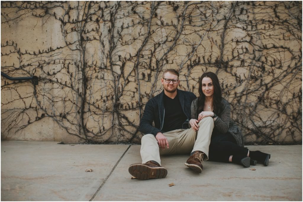 Intimate engagement portrait with Vine wall