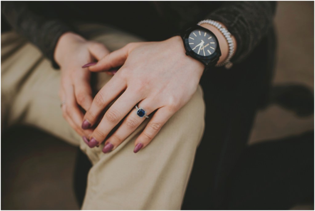 Engagement ring details with blacked out watch