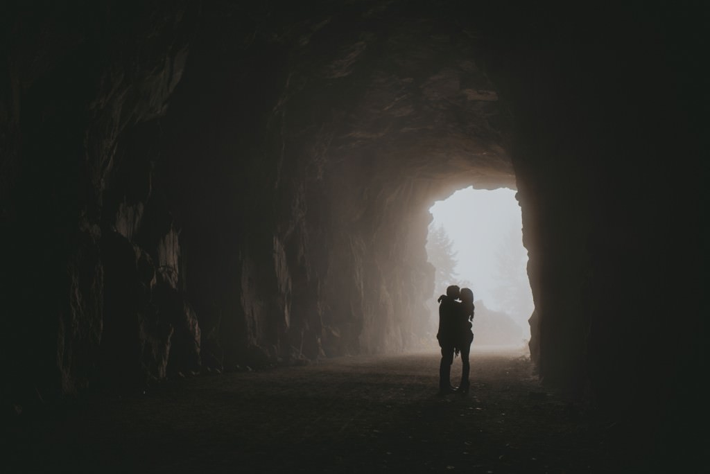 Foggy engagement session in a cave