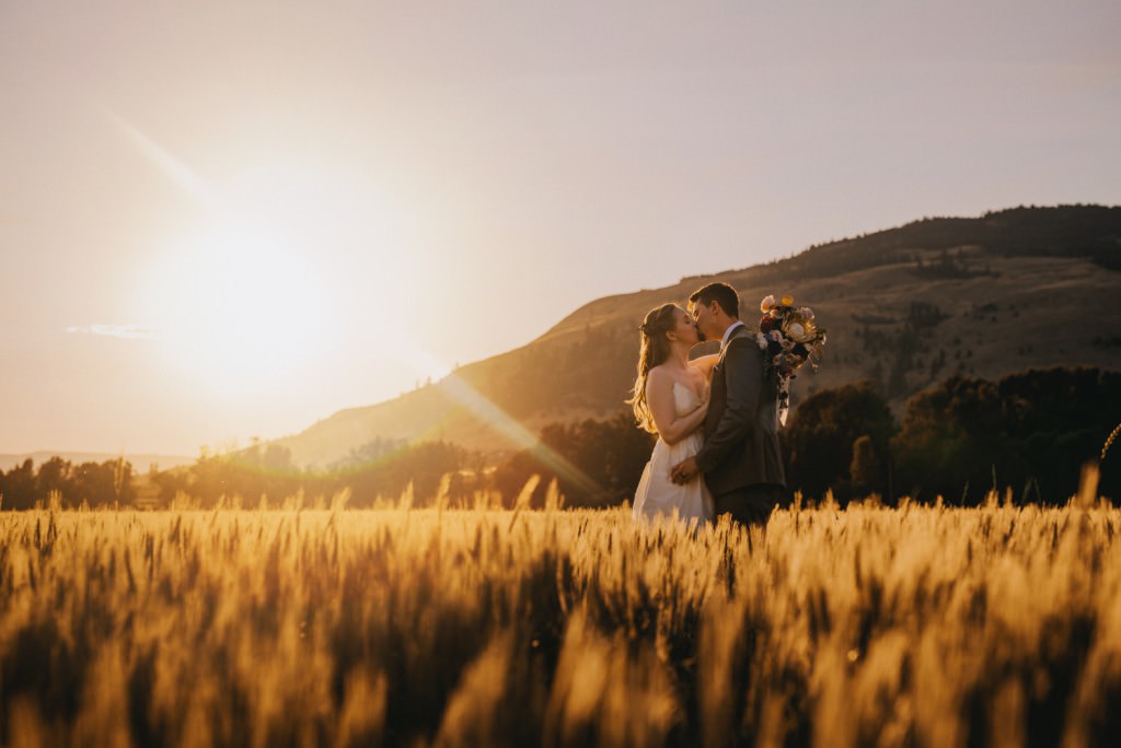 Stunning sunset in wheat field at wedding