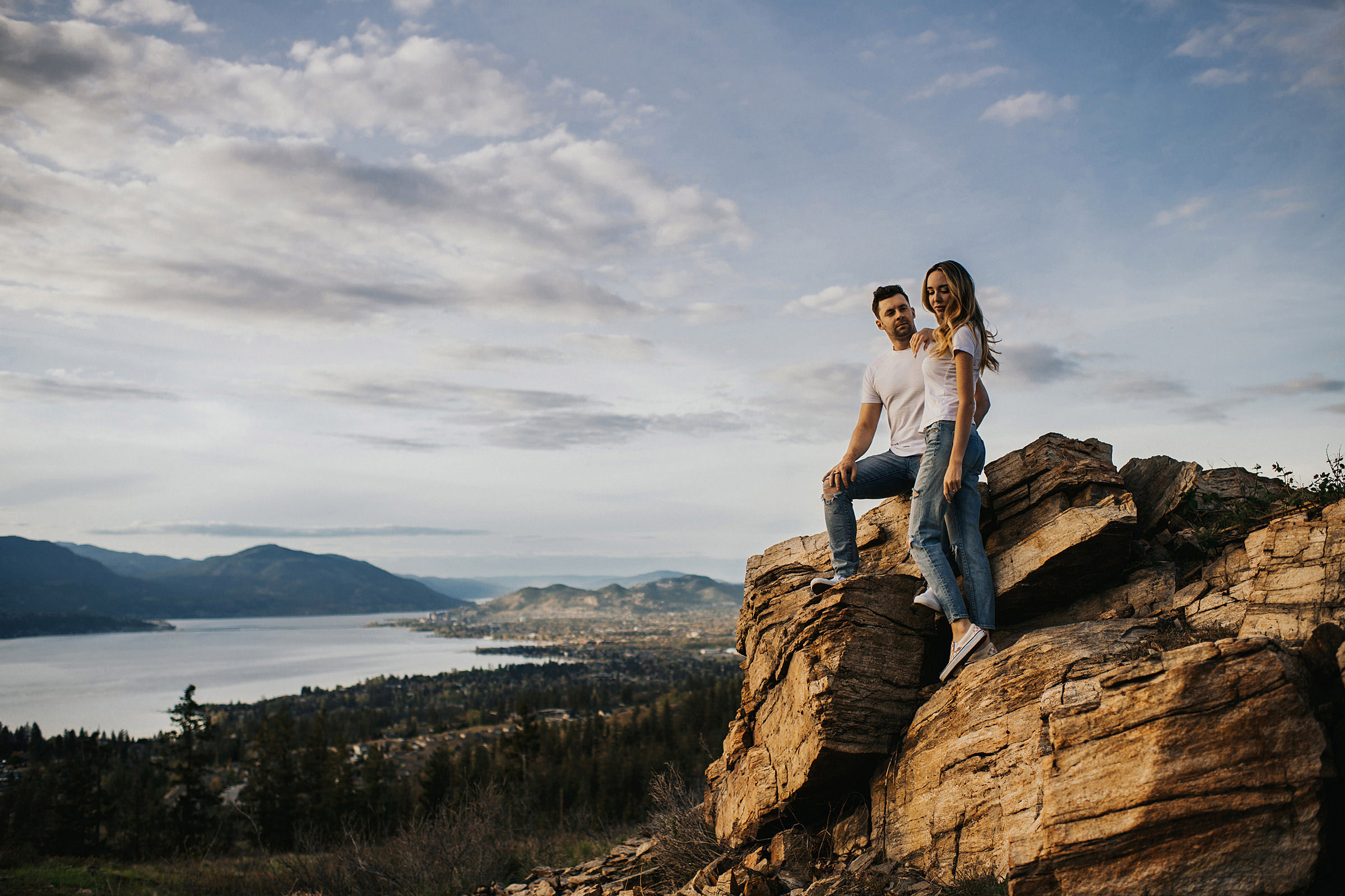 Adventurous engagement session on a mountaintop overlooking Kelowna