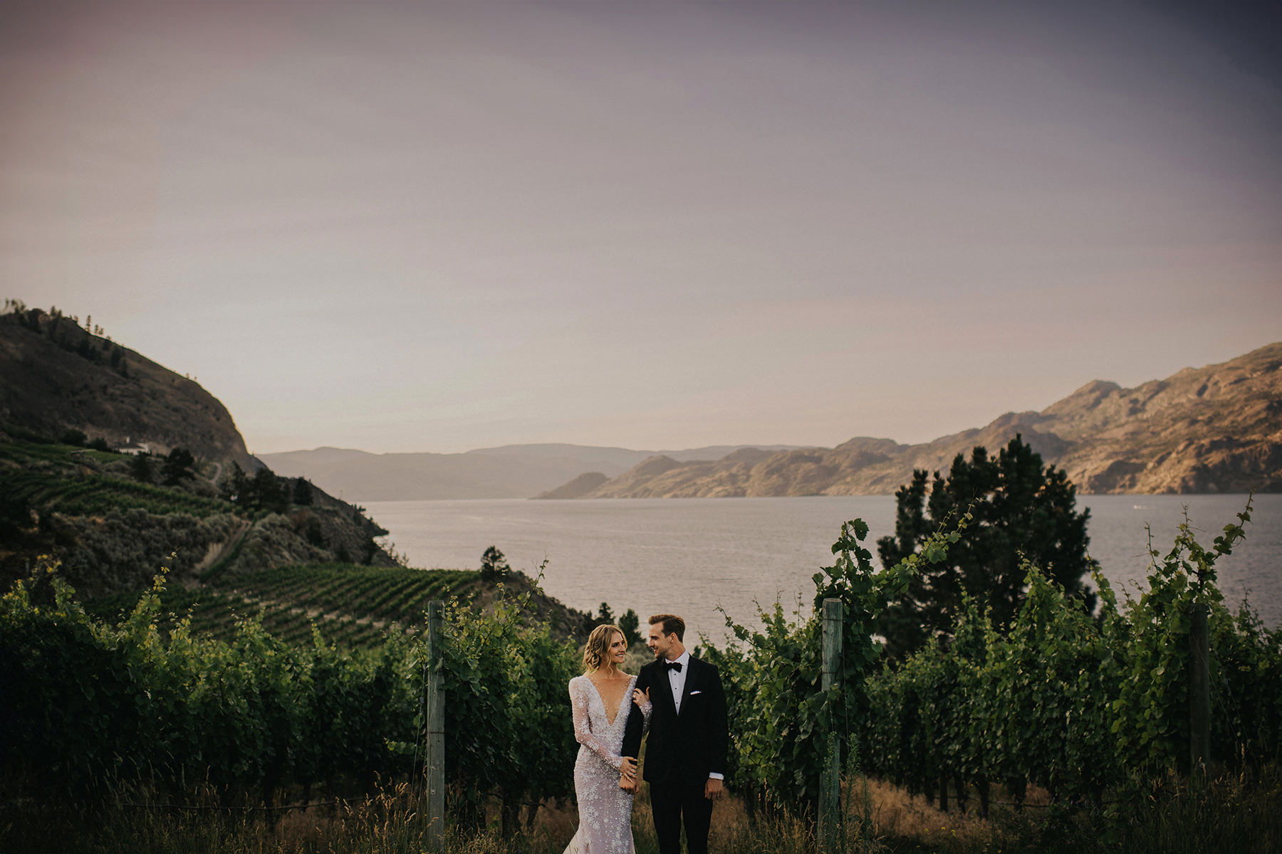 Jaw dropping landscape behind a bride and groom in Summerland at Oak Estate Winery